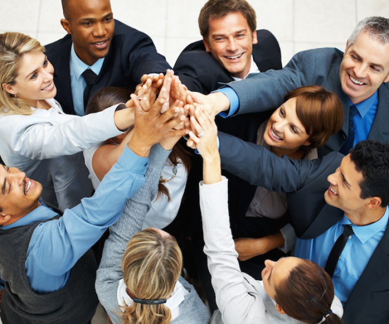 Group of executives placing their hands together